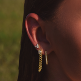 Side of Burdlife Model's head displaying 3 earrings including the Luxe Oval Hoops, the Refined Single Chain Earring and the Modish Triple Crystal Studs. 