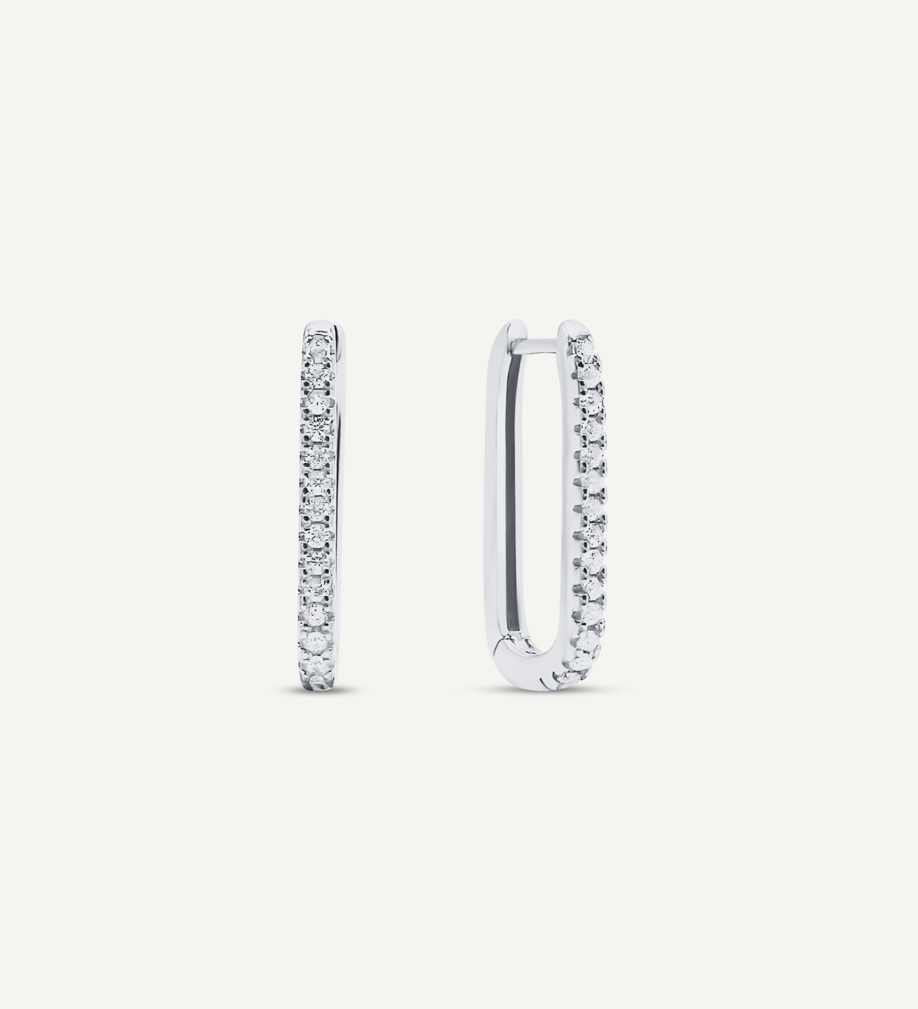 925 Sterling Silver oval shaped hoops that click close with a latch and are studded with small, round clear Cubic Zirconia crystals.